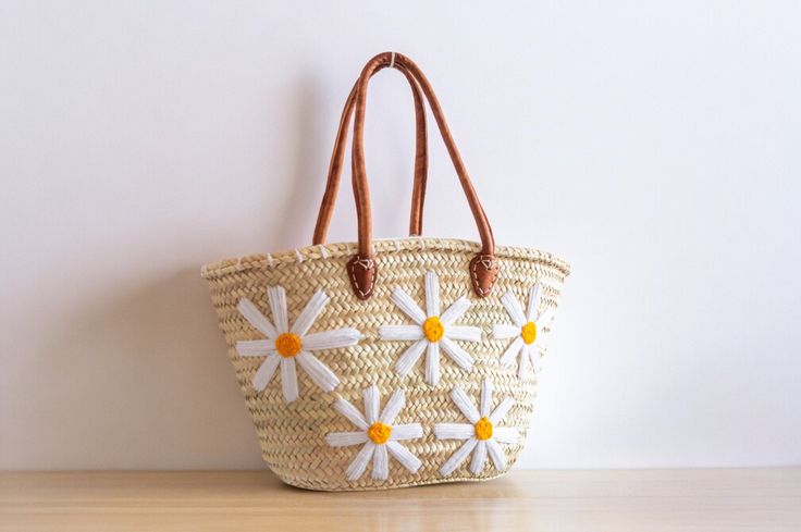 Discover the perfect blend of style and practicality with our Handwoven Straw Bag with Flowers Design. Crafted with precision from natural straw and adorned with a charming floral pattern, this stylish tote is ideal for various occasions, from casual outings to market trips. A beautifully crafted bag to accompany you everywhere. Straw Bag with Flowers Design - Shopping Basket - French Market Basket - Handcrafted Moroccan Basket Whether you're looking for a chic market tote, a charming everyday bag, or a thoughtful gift, this Straw Bag with Flowers Design is a perfect choice! Many of our customers also love using these bags as stylish storage or decorative accents at home. This bag is sturdy, durable, and will maintain its shape for years to come. Your bag might get slightly misshapen durin Casual Embroidered Natural Bag, White Bohemian Straw Bag For Spring, Spring White Bohemian Straw Bag, Embroidered Natural Straw Travel Bag, Spring Embroidered Tote Beach Bag, Spring Embroidered Beach Bag Tote, Beige Embroidered Straw Tote Bag, Embroidered Beige Straw Bag For Travel, Embroidered Crochet Tote Bag For Vacation