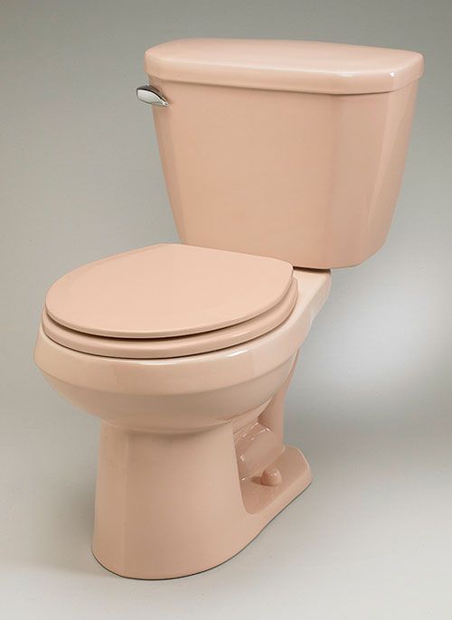 a pink toilet sitting on top of a white floor