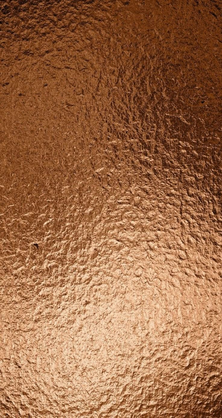 an image of a metallic surface that looks like it has been brushed with gold paint