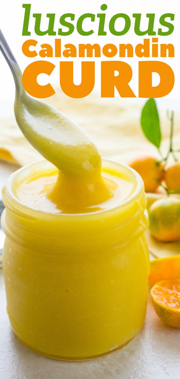 a jar filled with curd sitting on top of a table next to sliced oranges