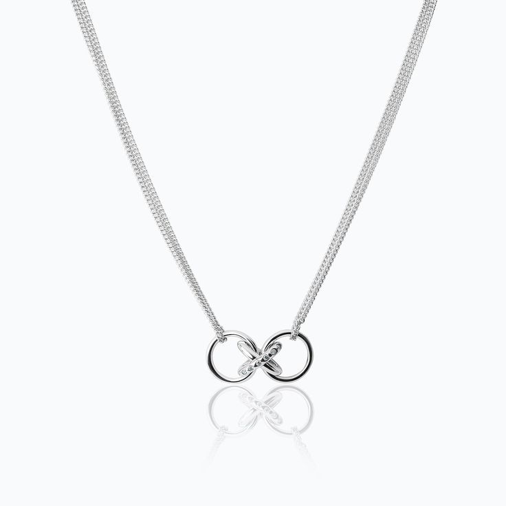 The X Diamonds Pendant is crafted by TANE in sterling silver with 8 round cut lab-grown diamonds with a total carat weight of 0.12. The central motif of the collection hangs from the double chain: two polished silver rings that come together in an X shape. One of the lines that intersects to form the X frames a row of diamonds. The piece takes its inspiration from the letter X, which is central to the word Mexico, in the same way that Mexico is central to the creative universe of TANE. As a seal Sterling Silver Infinity Necklace In White Gold, Luxury Silver Infinity Jewelry, Timeless White Gold Infinity Jewelry, Modern Sterling Silver Infinity Necklace, Sterling Silver Cable Chain Jewelry For Wedding, Timeless Sterling Silver Cable Chain Jewelry, Silver Infinity Chain Jewelry, Modern Sterling Silver Infinity Jewelry, Timeless Silver Infinity Jewelry