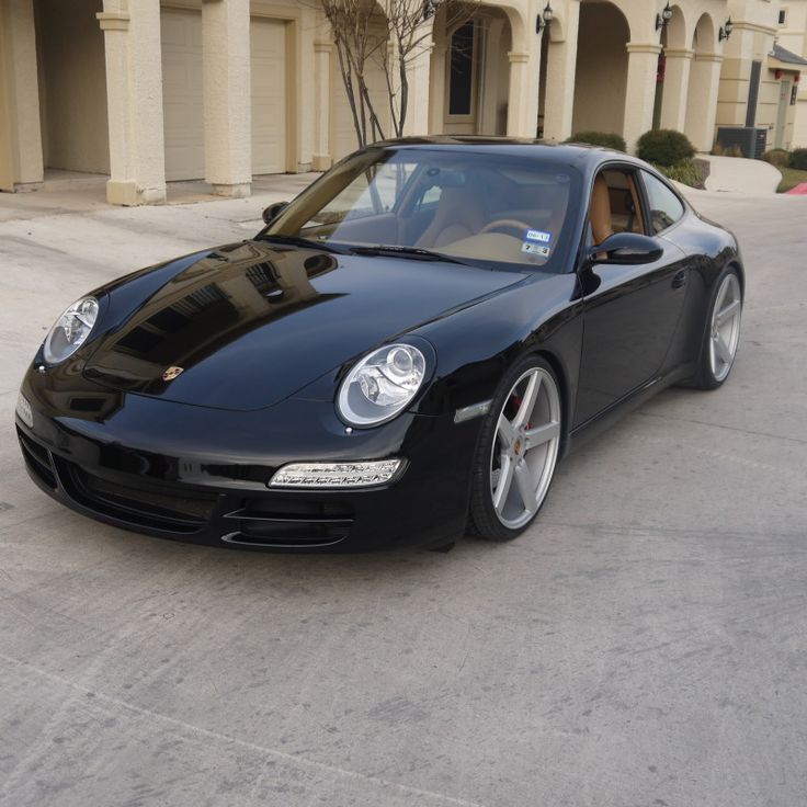 a black sports car parked in front of a building