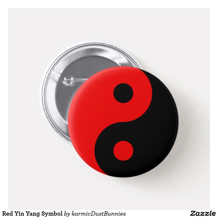 a red and black button with the symbol of yin on it's back side