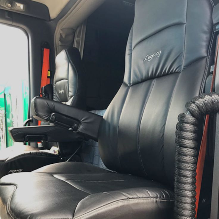 the interior of a truck with black leather seats