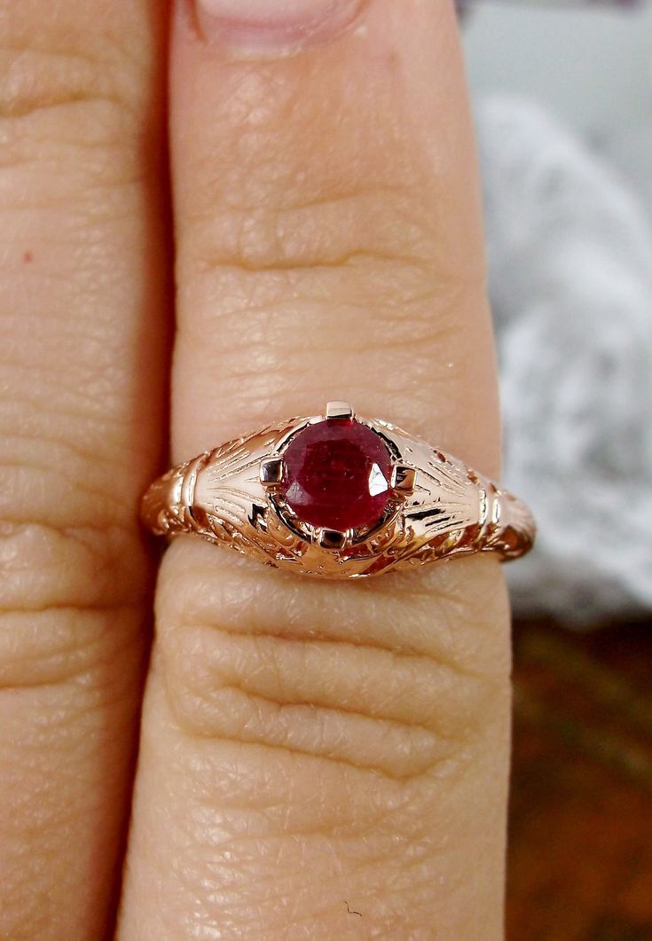 Natural Ruby Ring Description Floral Wedding Design#154 Custom This is a Victorian/Edwardian reproduction ring in 10k rose gold filigree with a natural red ruby gemstone solitaire. This full cut round cut red ruby gemstone is 4mm in diameter. The inside of the band is marked 10K for gold. Notice the beautiful floral design of the gold filigree setting. This is a lovely rendition of an Antique filigree ring, and it is ready to wear. A gift ring box is included and all rings are shipped in the rin Gold Filigree Ruby Wedding Ring, Gold Ruby Ring With Filigree For Wedding, Gold Ruby Ring With Intricate Design For Wedding, Ornate 14k Gold Ruby Ring For Anniversary, Vintage Ruby Ring With Filigree For Wedding, Rose Gold Filigree Wedding Jewelry, Rose Gold Filigree Jewelry For Wedding, Ornate 14k Gold Filigree Wedding Ring, Antique Ruby Filigree Wedding Ring