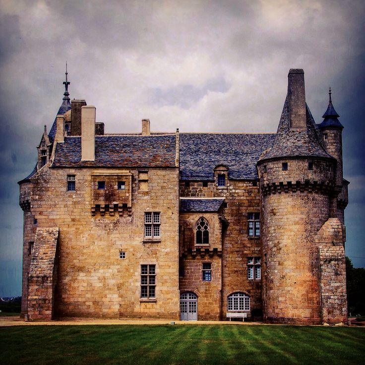 an old castle with two towers and windows