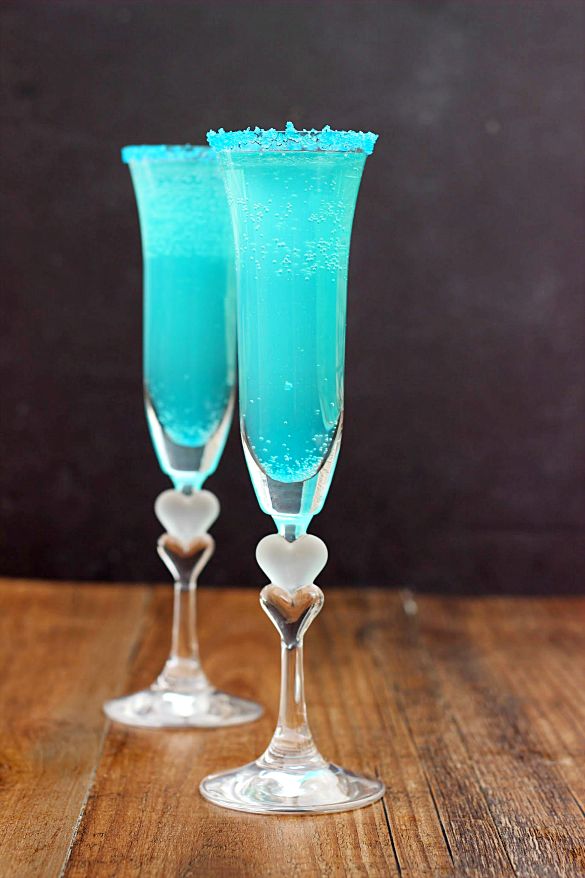 two champagne flutes with blue liquid in them