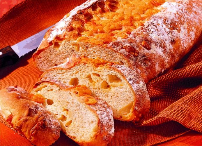 a loaf of bread sitting on top of a table next to a knife