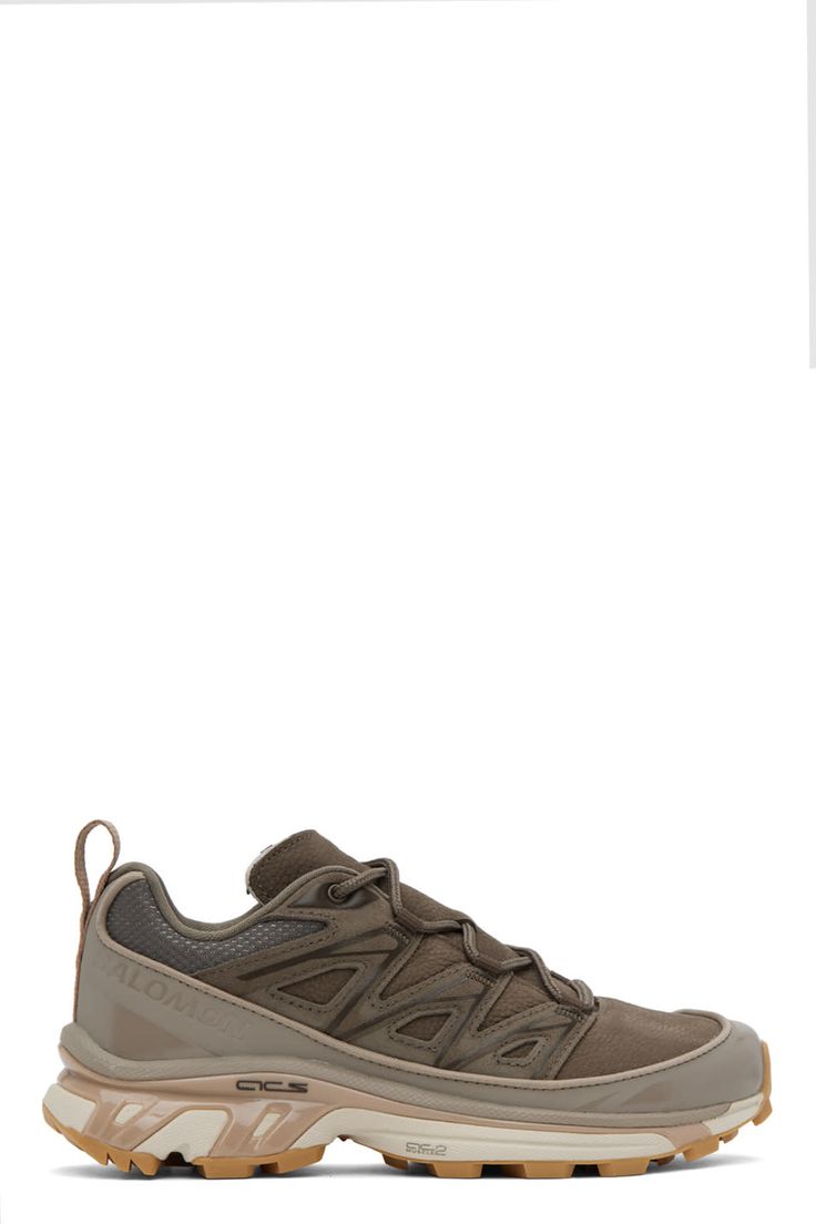 Low-top SensiFit™ grained leather, mesh, and suede sneakers in brown. · Reflective trim bonded throughout · Lace-up closure · Padded tongue and collar · Logo embossed at outer side · Webbing pull-loop at heel tab · Jersey lining · Molded OrthoLite® footbed · Agile Chassis™ System rubber midsole · Treaded Contagrip® rubber outsole Supplier color: Bungee cord/Wren/Almond milk Solomon Xt6, Solomon Shoes, Salomon Boots, Bungee Cord, Suede Sneakers, Sneakers Athletic, Almond Milk, Luxury Streetwear, Leather Sneakers