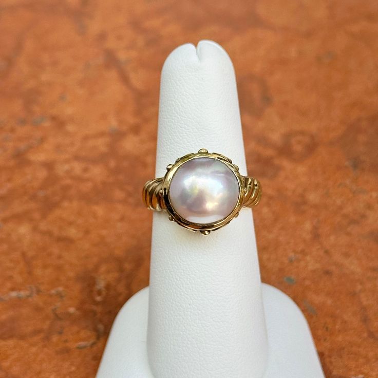 New, but old pieces, never worn, recently acquired from a premier jeweler located in Minneapolis, MN for many years- A rare opportunity! 14KT yellow gold genuine, bezel-set, Mabe pearl ring with Etruscan/ filigree design. Size 6.25 Sizable by us for a fee or your local jeweler Weight: 7.90 grams Band width: 4mm 11mm pearl Stamped 14k Antique Yellow Gold Oval Pearl Ring, Antique Oval Yellow Gold Pearl Ring, Luxury Yellow Gold Pearl Ring With Cabochon, Yellow Gold Pearl Ring With High Luster, Fine Jewelry Yellow Gold Pearl Ring With High Luster, Classic Wedding Jewelry With Cabochon, Heirloom High Luster Oval Pearl Ring, Classic Oval Ring With High Luster, Classic Pearl Ring With Gemstone For Anniversary