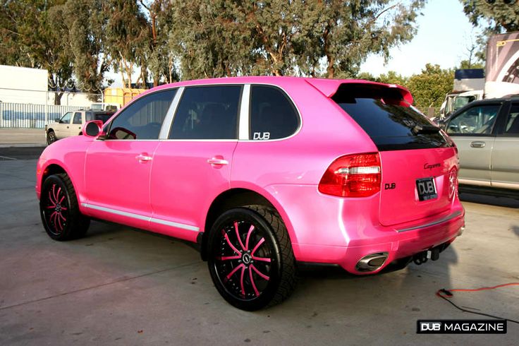 a pink car is parked in a parking lot