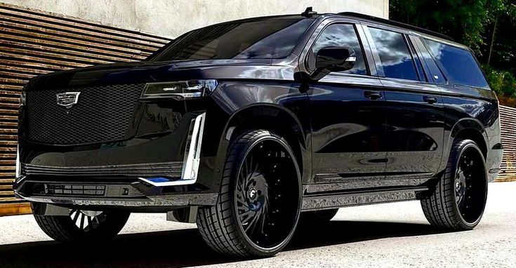 a black suv parked in front of a building