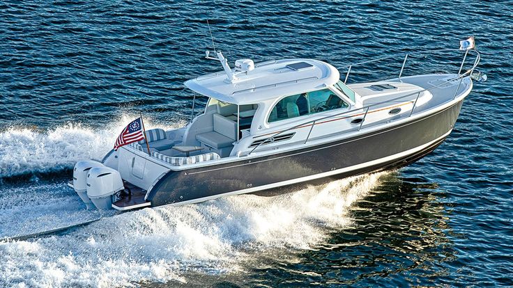 a small motor boat with an american flag on the front is speeding through the water