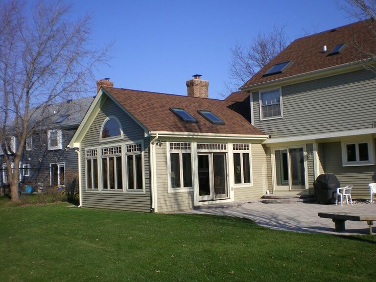 a house that has a patio in front of it and some windows on the roof