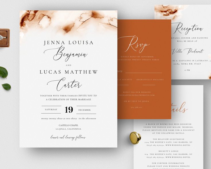 the wedding stationery is laid out on top of each other, including an orange and white marbled paper