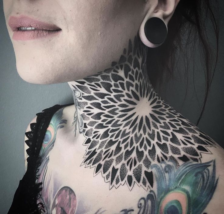 a woman with tattoos on her neck and chest