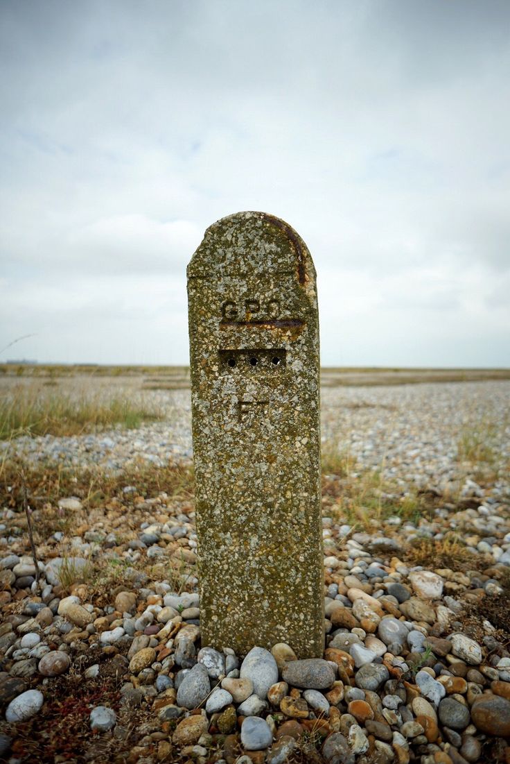 an old grave in the middle of a gravel field