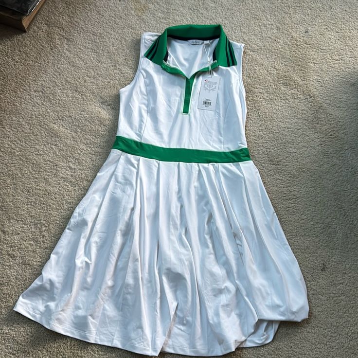 Lady Hagen White And Green Golf/Tennis Dress With Underlying Short. Slight Pleat To Skirt. Fits Larger, Like A Medium. May Fit A Large As Well. Unworn. New With Tag. Fitted White Tennis Dress With Short Sleeves, Green Tennis Dress For Summer, Green Tennis Skirt For Summer, Green Summer Tennis Dress, Sleeveless Green Tennis Dress For Spring, Casual Green Tennis Dress For Spring, White Short Sleeve Tennis Dress, Preppy Tennis Skirt For Summer, Preppy Fitted White Dress