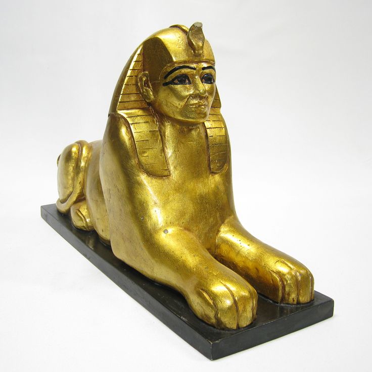 a golden statue sitting on top of a black base