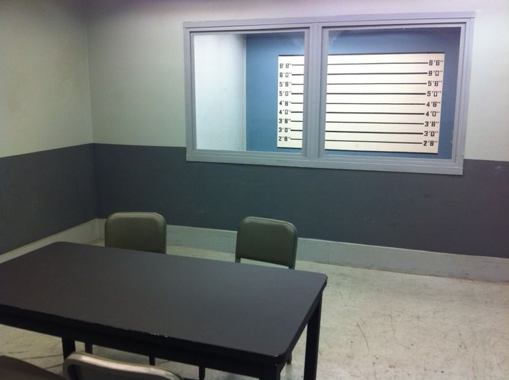 an empty room with two chairs and a table in front of a window that has shutters on the windowsill