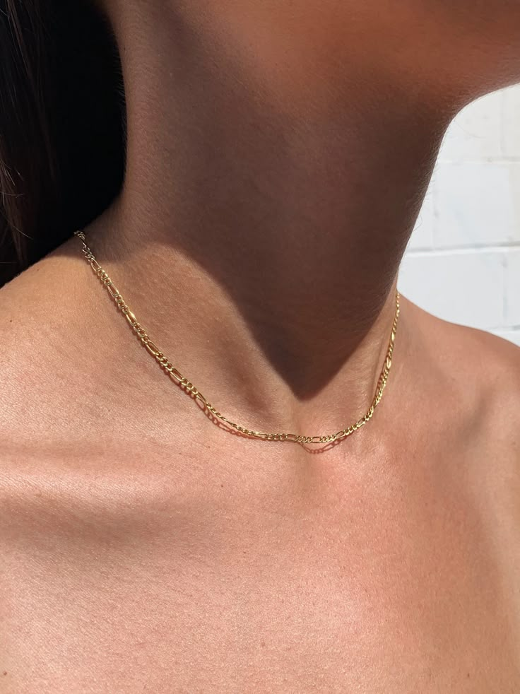 DESCRIPTIONAn everyday chain with a traditional pattern that is cool enough to wear on its own or layered with others. Made hollow to keep it lightweight and easy to wear. DETAILS- always made in 14k gold- chain width: 2.6mm- model wears a 16" in second photo and 24" in fourth photo Small Gold Chain, Chains Aesthetic, Real Gold Chains, Minimalist Necklace Gold, Figaro Chain Necklace, Real Gold Jewelry, Bling Necklace, Traditional Pattern, Gold Fashion Necklace