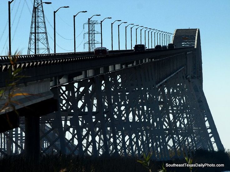 an image of a bridge that is going over the water with power lines above it