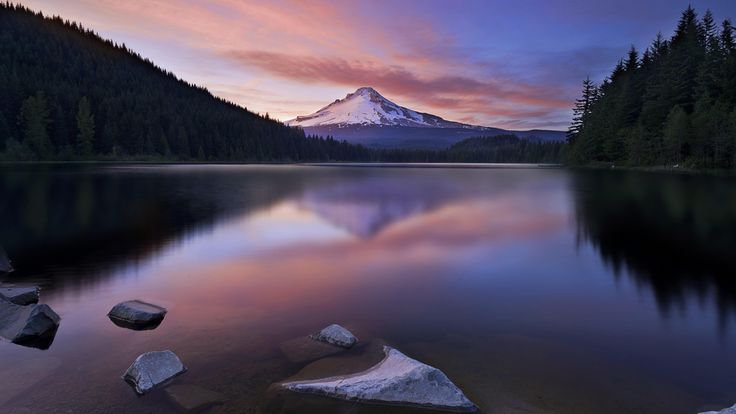 a mountain is shown in the distance as it sits on top of a lake