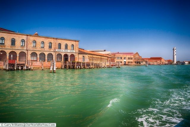 the water is green and blue with buildings on it's sides in venice, italy