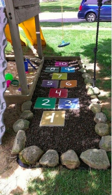 a child's play area with rocks and numbers