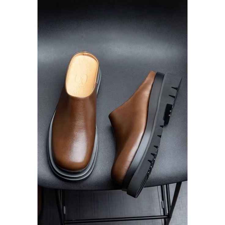 Step into luxury and style with our Opulent LuxeLeather Business Beach Slippers. Crafted with genuine cow leather and pigskin lining, these brogue slippers exude sophistication. The slip-on design and rubber outsole provide comfort and ease, while the 5.5cm heel adds a touch of elegance. Elevate your footwear collection with these opulent slippers today. Experience the epitome of luxury and style with our Opulent LuxeLeather Business Beach Slippers. Crafted with genuine cow leather and pigskin lining, these brogue slippers exude sophistication. Slip into comfort and ease with the slip-on design and rubber outsole, while the 5.5cm heel adds a touch of elegance. Elevate your footwear collection with these opulent slippers today. Indulge in the ultimate luxury and style with our Opulent LuxeL Comfortable Leather Mules With Almond Toe, Leather Clogs With Textured Sole And Closed Toe, Leather Closed Toe Mules With Textured Sole, Casual Leather Clogs With Textured Sole, Leather Mules With Textured Sole And Almond Toe, Leather Sole Slip-ons With Closed Toe, Leather Slip-ons With Leather Footbed, Casual Platform Slippers With Leather Footbed And Round Toe, Brown Leather Slip-ons For Work