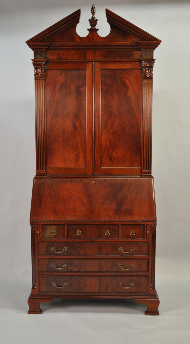 an antique wooden dresser with two doors and drawers