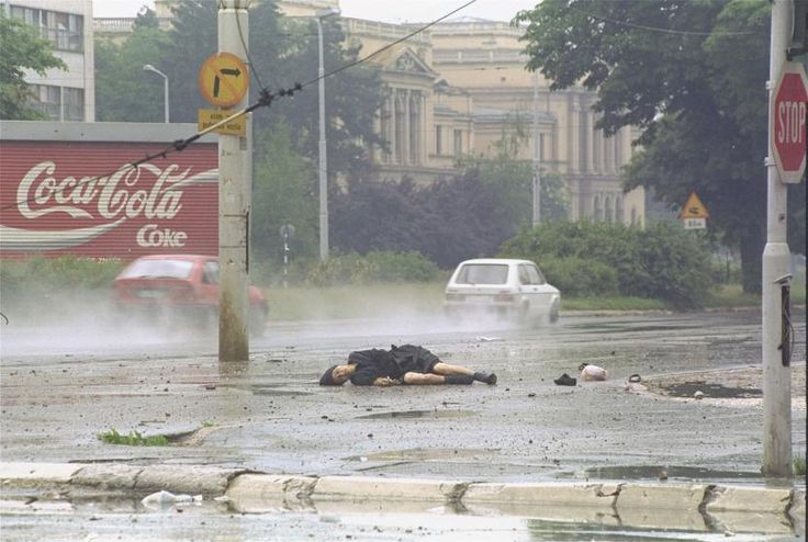 a person laying in the middle of a flooded street