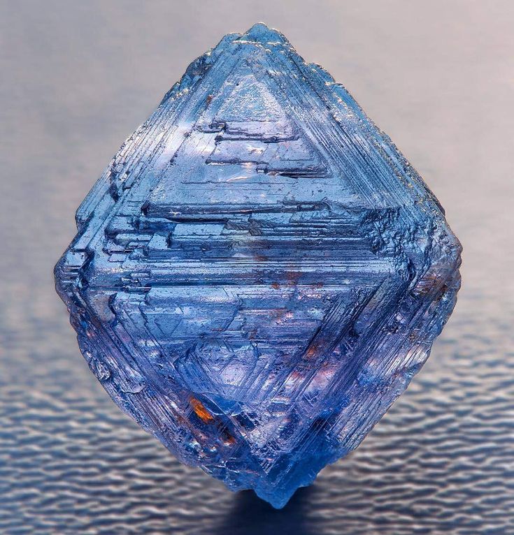 a blue diamond sitting on top of a table