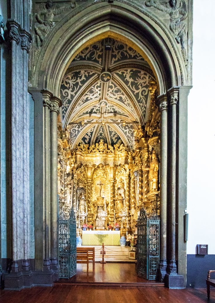 the inside of an ornate church with wooden floors