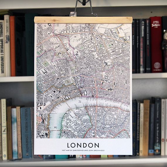 a map hanging on a book shelf in front of books