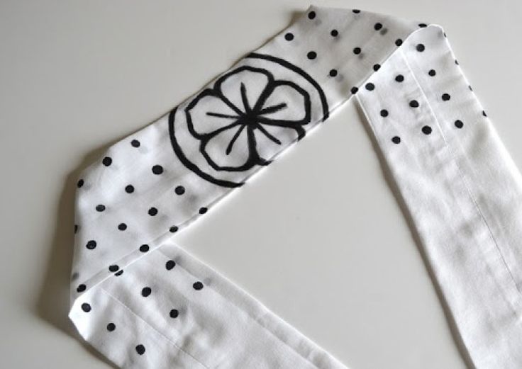 two pieces of fabric with black and white polka dots on them, one piece has a lemon in the center