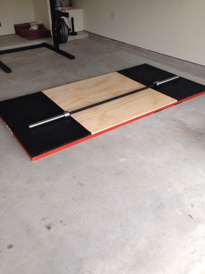 the floor is made out of plywood and black mat with red trim on it