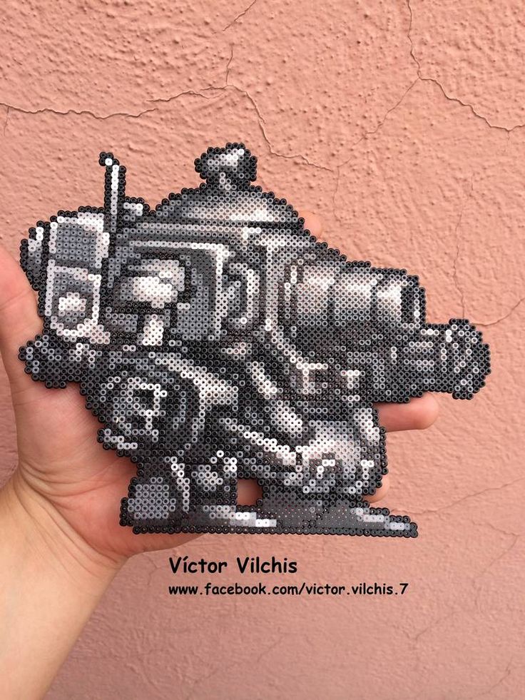 a person holding up a piece of art made out of pixellated photoshopped to look like a robot