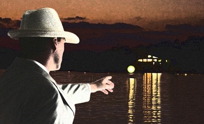 a man in a hat is looking at the water