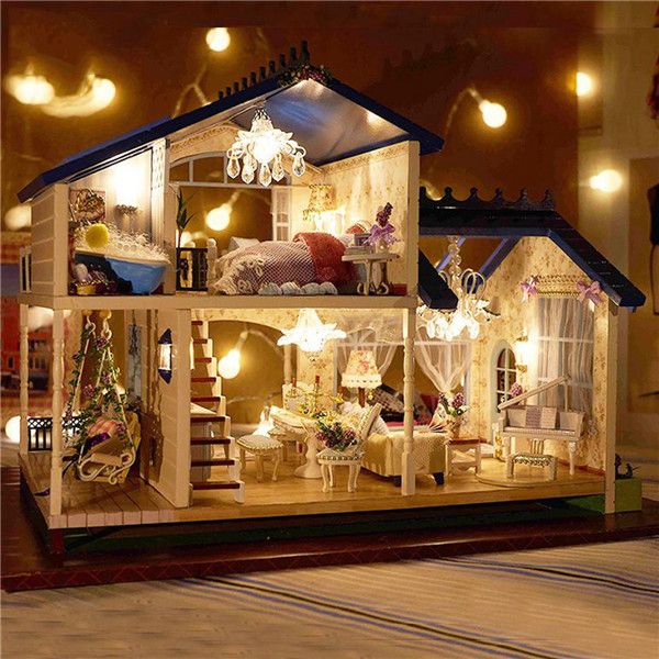 a doll house with lights and furniture inside