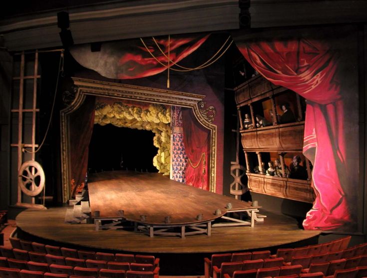 an empty theatre stage with red curtains