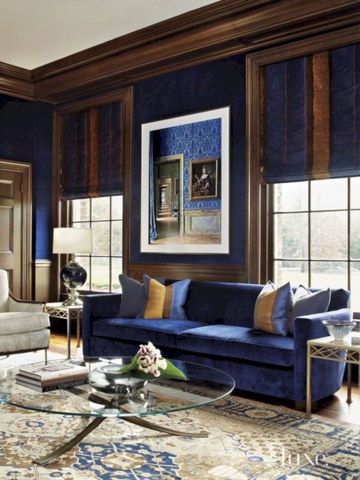 a living room filled with furniture and blue walls