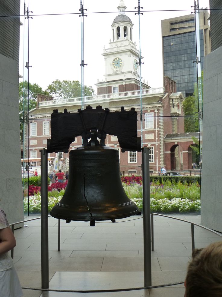 there is a large bell in the middle of this building