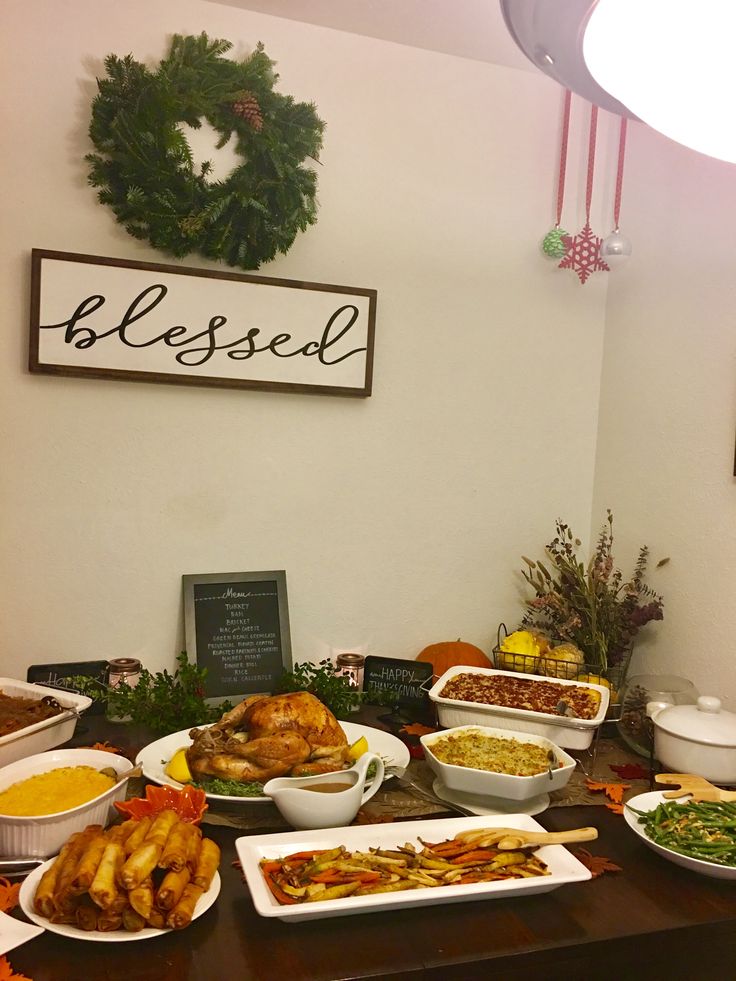 a table filled with lots of food on top of it next to a sign that says blessing