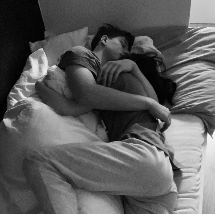 black and white photograph of a woman sleeping on a bed with her head in the pillow