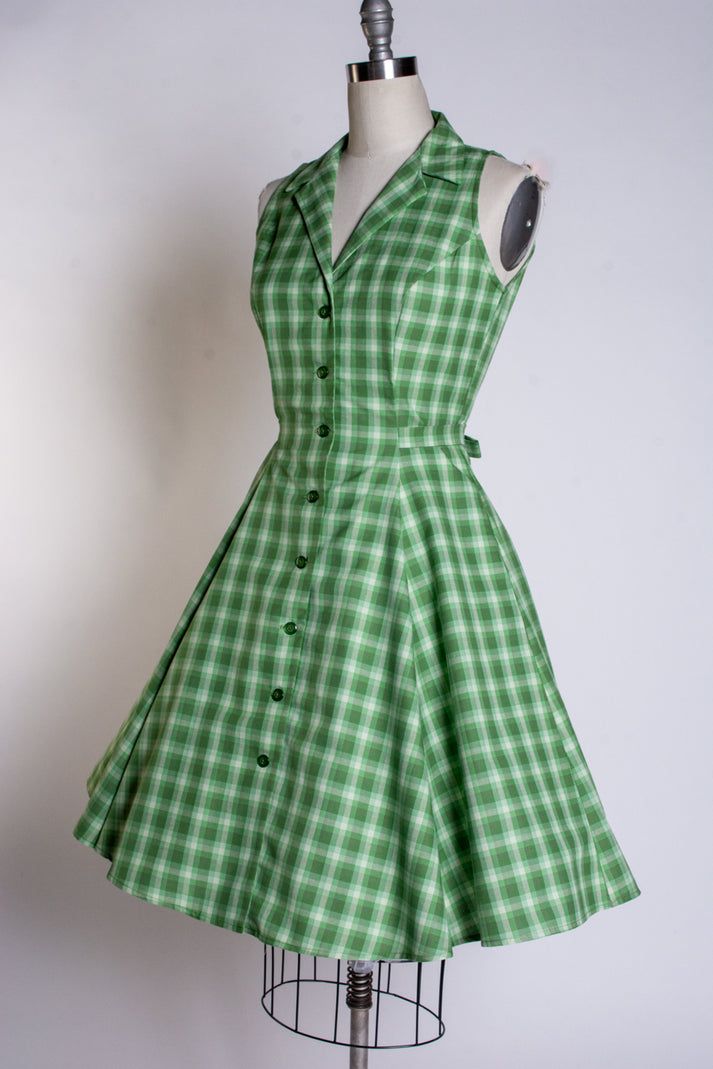 Betty Lou Dress - Green Tonal Plaid – Heart of Haute Classic A-line Cotton Shirt Dress, Fitted A-line Shirt Dress For Casual Wear, Fitted A-line Dress With Button Back, Summer Dresses With Fitted Bodice And Buttons, Fitted A-line Shirt Dress With Buttons, Classic A-line Vintage Dress With Buttons, Sleeveless Dress With Button Closure For Garden Party, Classic Vintage A-line Dress With Fitted Bodice, Classic A-line Vintage Dress With Button Closure