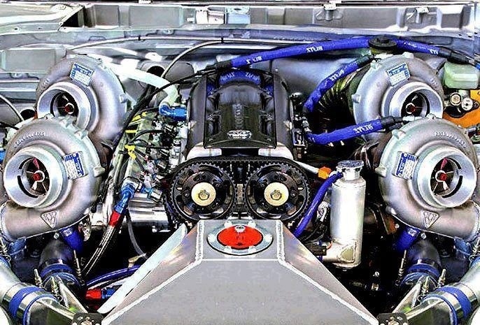 the engine compartment of a car with multiple turbos