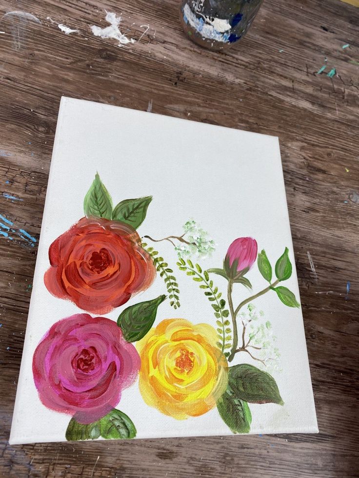 the painting is being made with watercolors on paper, and it looks like flowers