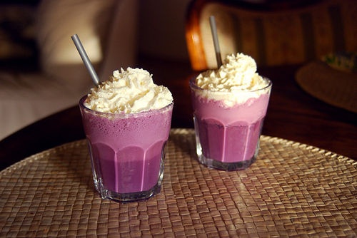 two glasses filled with ice cream on top of a table