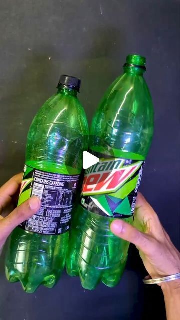 two bottles of mountain dew are being held by someone's hand in front of the camera